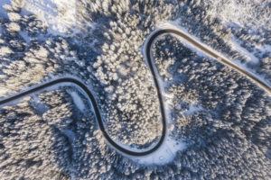 Aerial view of curvy road in snowy landscape