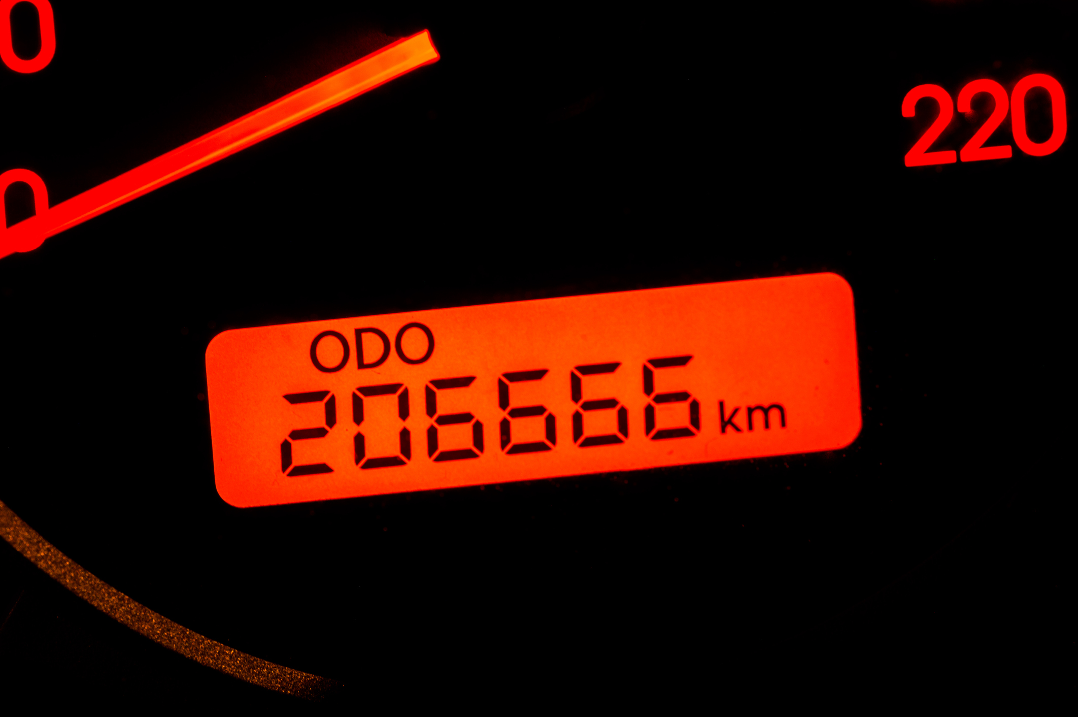 Dark dashboard with odometer showing kilometers.